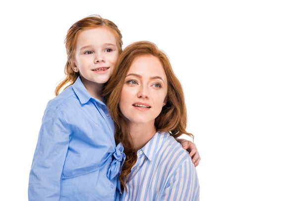 beautiful redhead mother and daughter smiling and looking away isolated on white - Zdjęcie, obraz