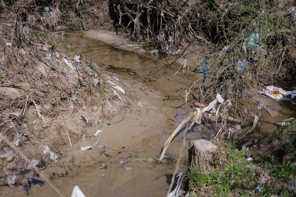 Yerli çöplerle dolu yoğun kirlenmiş su akıntısı - Fotoğraf, Görsel