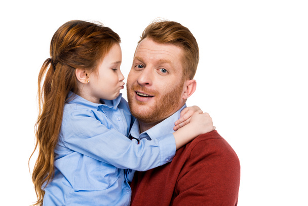 cute little daughter hugging and kissing happy father isolated on white - Foto, afbeelding