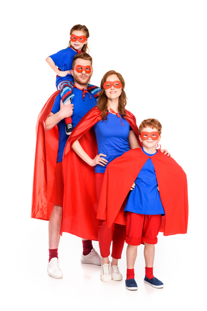 family of superheroes in masks and cloaks smiling at camera isolated on white - Foto, imagen