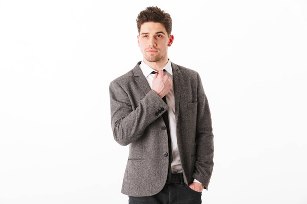 Calm business man in jacket with arm in pocket - Fotó, kép