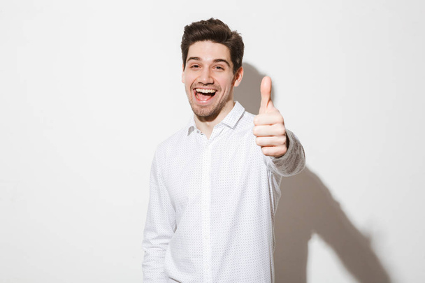 Portrait of a happy young man dressed in shirt - Fotó, kép