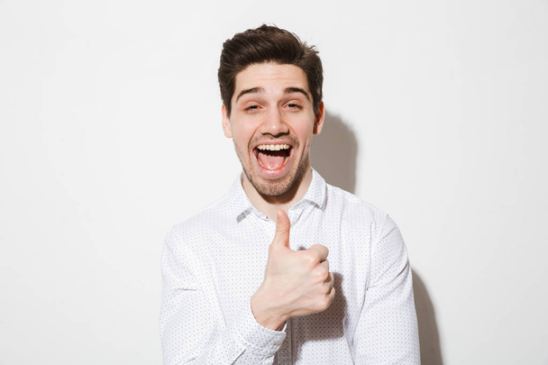 Portrait of a cheerful young man dressed in shirt - Φωτογραφία, εικόνα