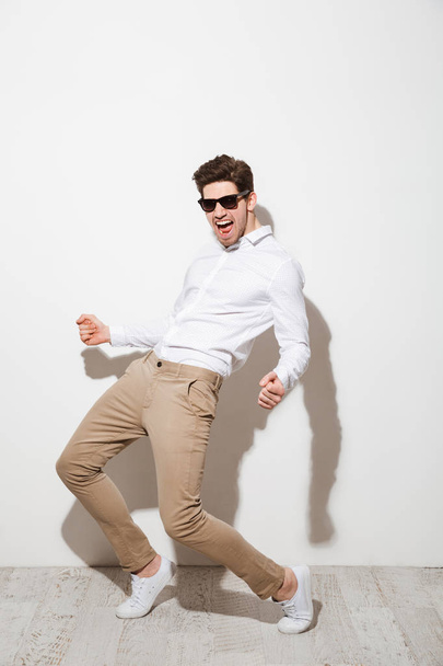 Full length portrait of an excited young man - Fotografie, Obrázek