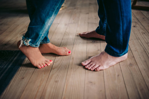 Legs of a couple in jeans without shoes - Fotoğraf, Görsel
