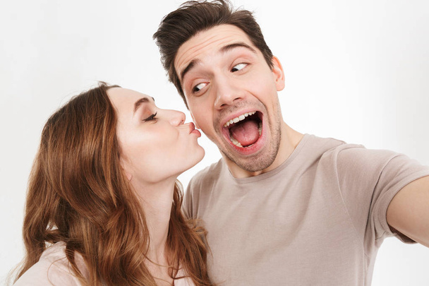 Close up portrait of a happy young couple taking a selfie - Photo, Image