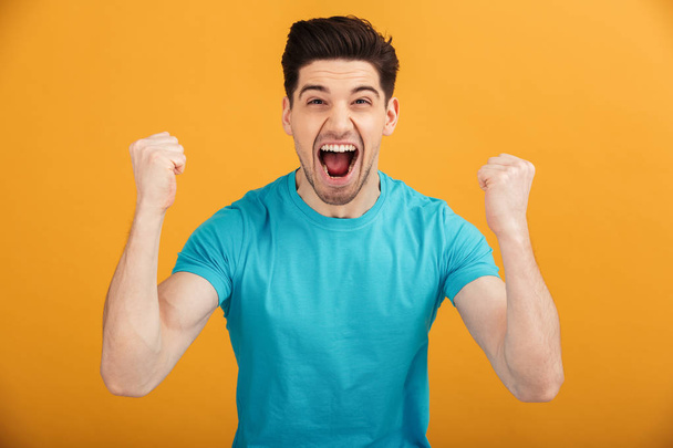 Portrait of an excited young man in t-shirt - Foto, imagen