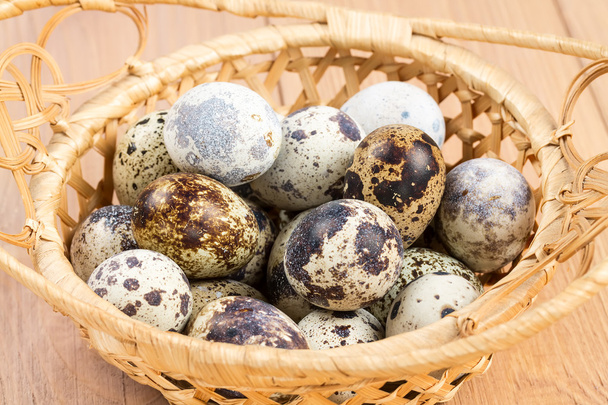 Quail eggs in a straw basket - Photo, Image