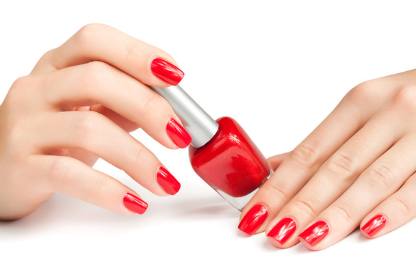 Hands with red manicure and nail polish bottle isolated - Foto, immagini