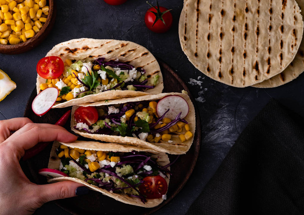 Pulled pork tacos with red cabbage, tomatoes, corn, feta and avocados overhead shot. - Foto, Imagen