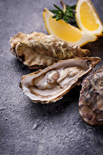 Fresh oysters with lemon and rosemary - Photo, Image
