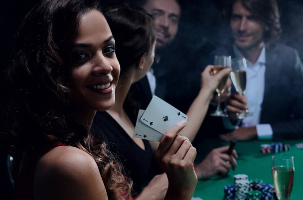adult group celebrating friend winning blackjack - Фото, зображення