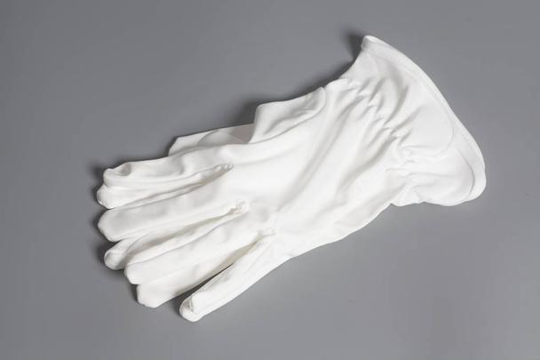 White service gloves on gray background - Foto, afbeelding