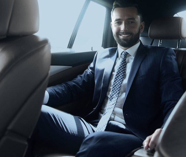 businessman sitting in the back seat of a car - Zdjęcie, obraz