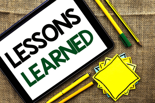 Text sign showing Lessons Learned. Conceptual photo Experiences that should be taken into account in the future written on Tablet on the jute background Pens Pencil and Sticky Note Papers - Photo, Image