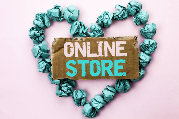 Writing note showing  Online Store. Business photo showcasing Internet related business Website where you can buy in the net written on Tear Cardboard on Plain background on Heart Paper Balls. - Photo, Image