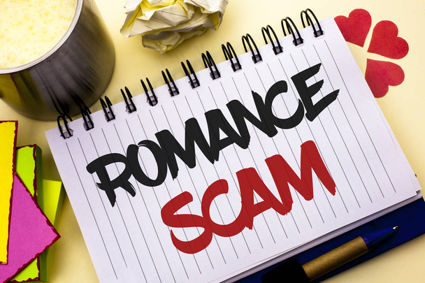 Writing note showing  Romance Scam. Business photo showcasing Dating Cheat Love Embarrassed Fraud Cyber Couple Affair written on Notebook Book on the plain background Cup Pen Hearts - Photo, Image