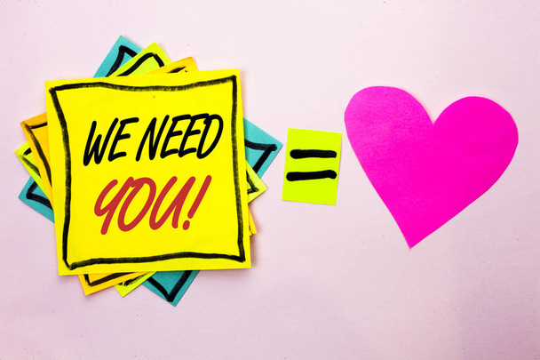 Text sign showing We Need You Motivational Call. Conceptual photo Company wants to recruit Employee required written on Yellow Sticky Note Paper on the plain background Pink Heart next to it. - Photo, Image