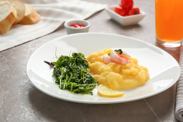 Plate with fresh tasty shrimp and grits on table - Фото, зображення