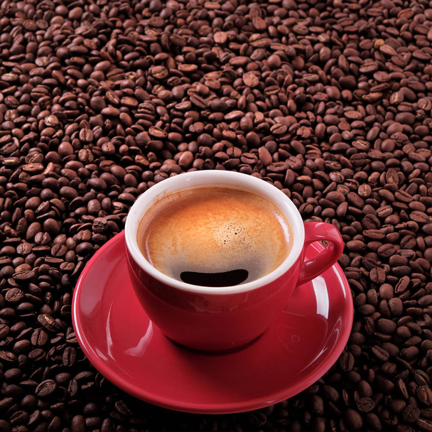 Red coffee cup espresso roasted beans background - Photo, Image