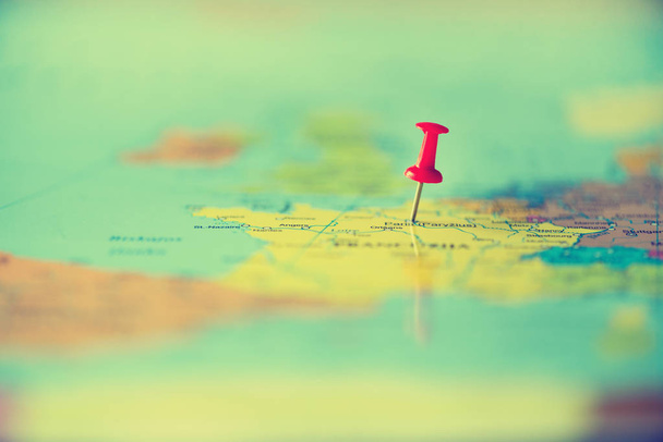 Red pushpin, thumbtack, pin showing the location, travel destination point on map. Copy space, lifestyle concept - Photo, Image
