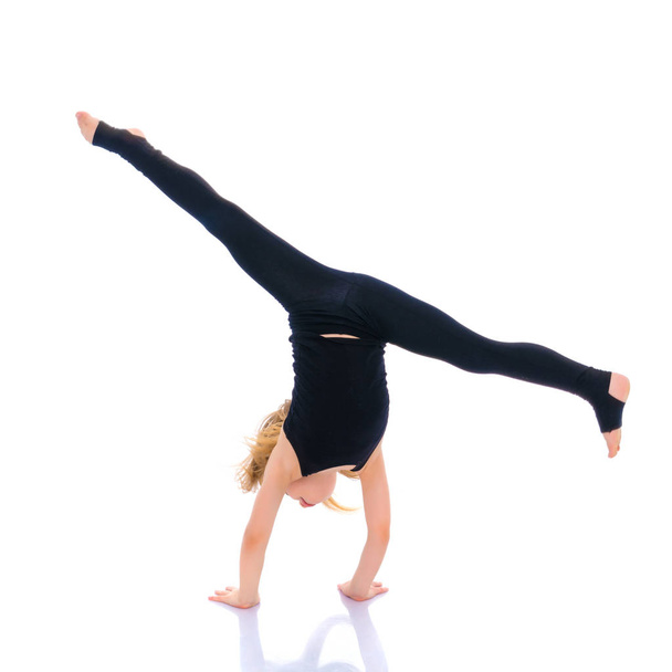 girl gymnast performs a handstand. - Фото, зображення