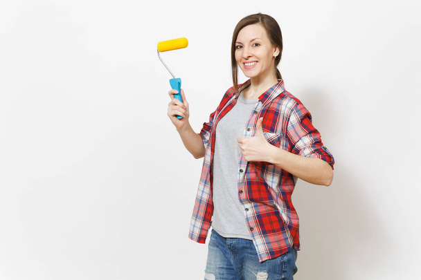 Young smiling beautiful woman holding paint roller for wall painting and showing thumb up isolated on white background. Instruments, accessories for renovation apartment room. Repair home concept. - Foto, Bild