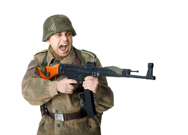 Soldier shoots submachine gun - Фото, изображение