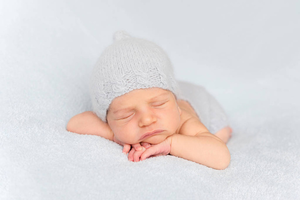 Tender newborn sleeping on belly - Fotografie, Obrázek