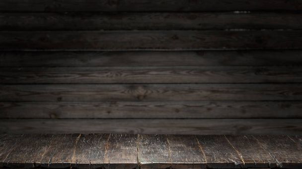 Old wooden tabletop and wooden wall at the background.  - Фото, изображение