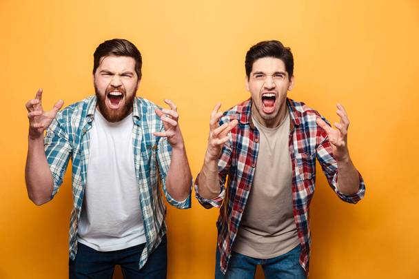 Portrait of a two angry young men shouting loud - Фото, изображение