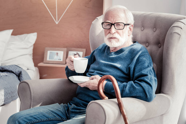 Aged bearded man resting in the armchair - Fotografie, Obrázek