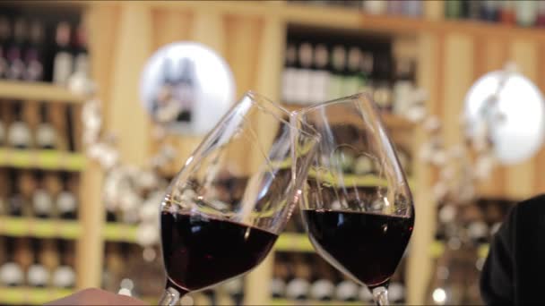 Man and woman drinking red wine. Close-up hands with glasses. Close up of hands of young loving couple clinking glasses of red wine - Footage, Video
