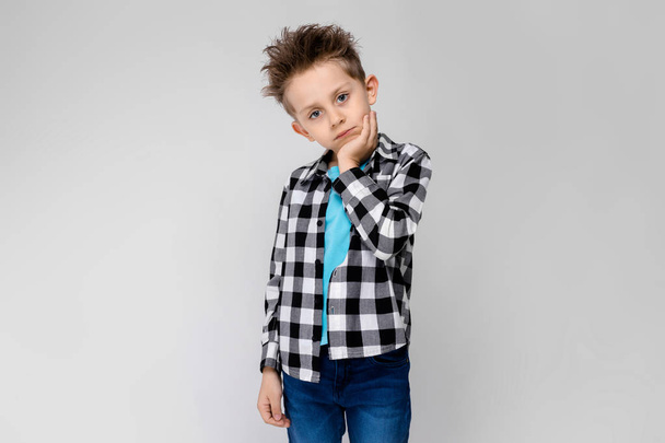 Nice caucasian preschooler boy in casual outfit showing different expressions on white wall in studio.  - Photo, Image