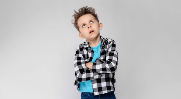 Nice caucasian preschooler boy in casual outfit showing different expressions on white wall in studio.  - Valokuva, kuva
