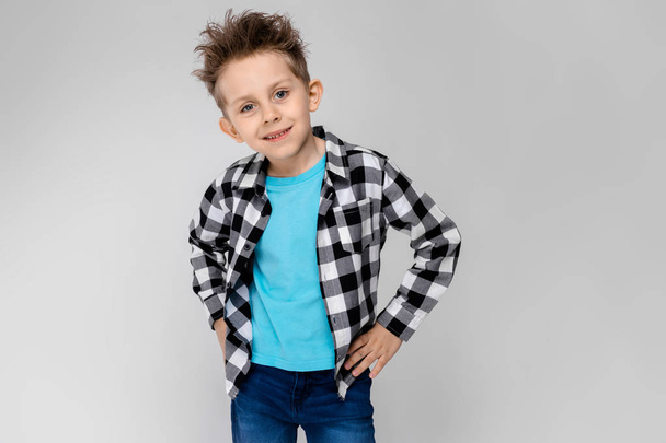 Nice caucasian preschooler boy in casual outfit showing different expressions on white wall in studio.  - 写真・画像