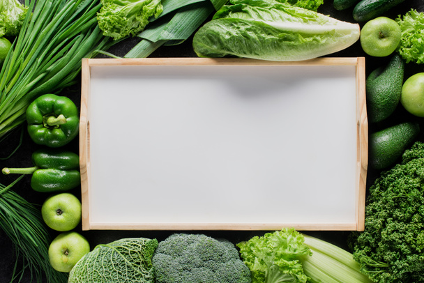 top view of blank tray between green vegetables, healthy eating concept - 写真・画像