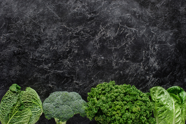 top view of broccoli, savoy cabbage and parsley on concrete table, healthy eating concept - Photo, image