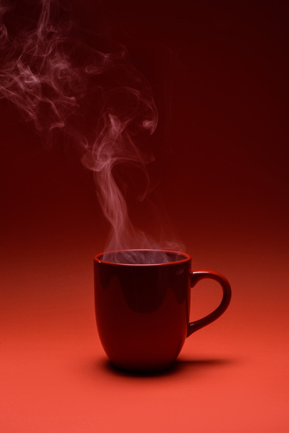 close up view of red cup of coffee isolated on red - Photo, Image