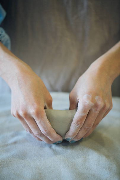 Hands make clay from various items for home and sale in the store and at the exhibition, ceramic items are made in hand, the clay billet becomes a ceramic dish, the ceramic master sculpts a beautiful product - 写真・画像