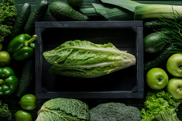 top view of cabbage in wooden box between green vegetables, healthy eating concept - Foto, Imagen