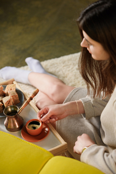 selective focus of young woman with cup of coffee on wooden tray at home - Fotografie, Obrázek