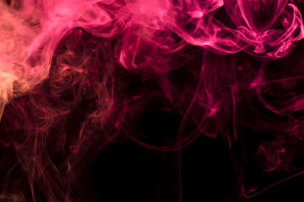 Thick  red colorful smoke on a black isolated background. Background from the smoke of vape - Foto, afbeelding