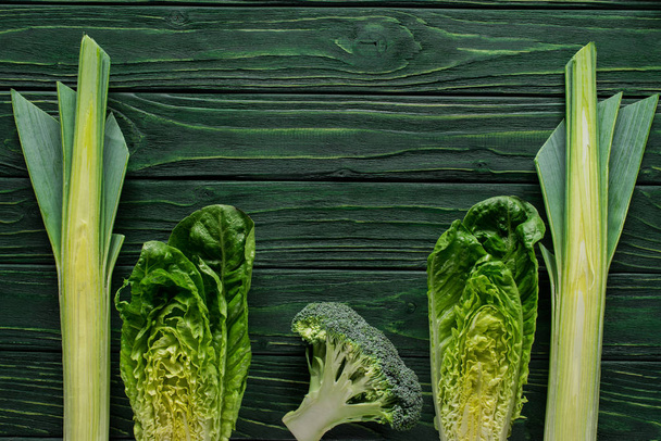 top view of green leek, cabbage and broccoli on wooden table, healthy eating concept - Fotoğraf, Görsel