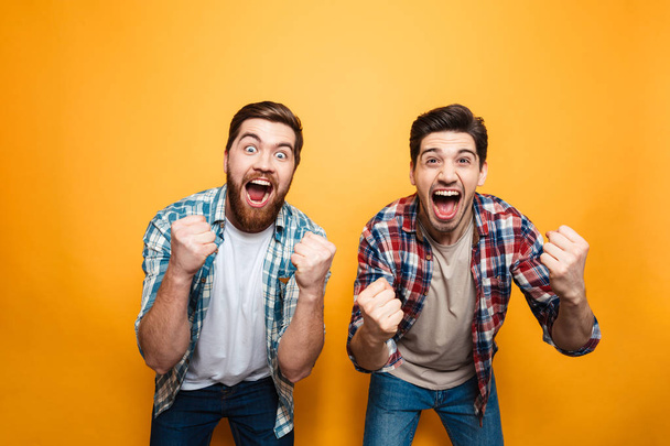 Portrait of a two happy young men celebrating - Foto, Imagem