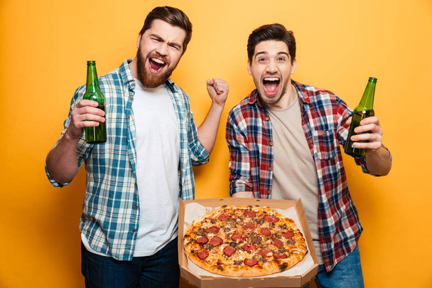 Portrait of a two happy young men drinking beer - Φωτογραφία, εικόνα