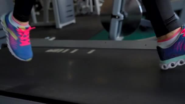 Woman running on treadmill in gym, slow motion - Záběry, video