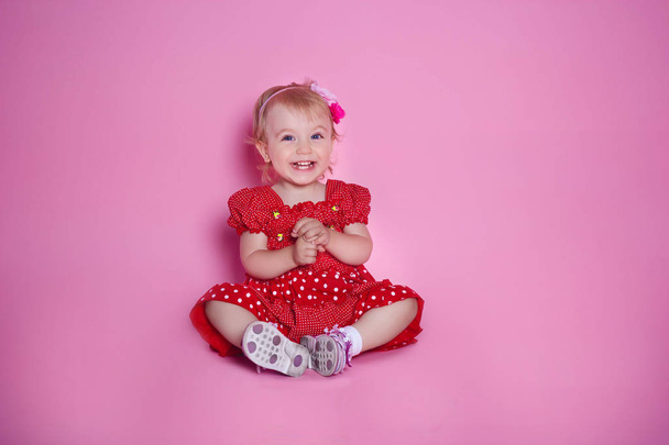 Little girl smiling on a pink background - Photo, Image