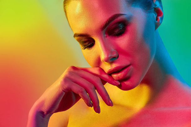 High Fashion model woman in colorful bright lights posing in studio - Zdjęcie, obraz