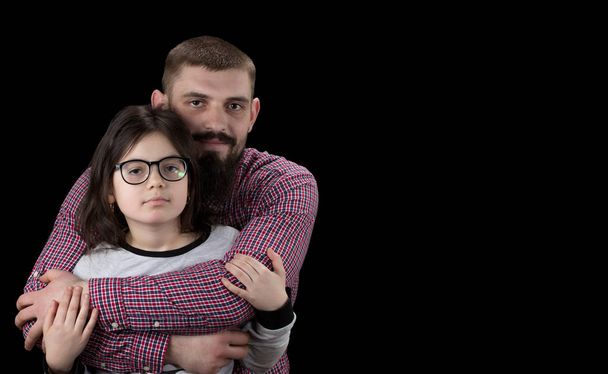 Portrait of handsome father and his cute daughter hugging, looki - Photo, Image